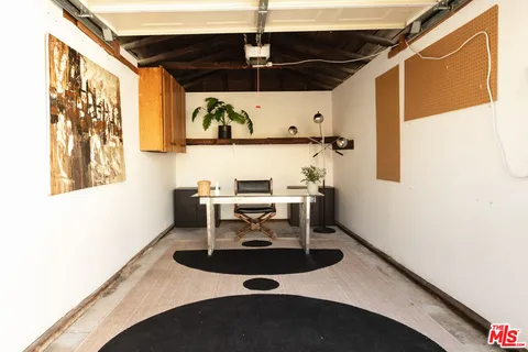a living room with a table and white walls
