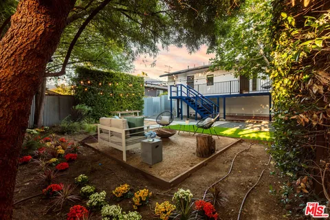 a view of a backyard with sitting area