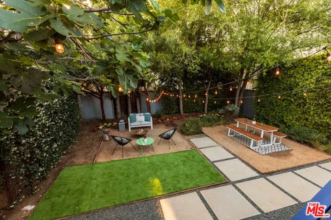 a view of a backyard with sitting area