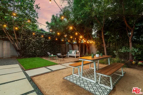 a view of a backyard with sitting area