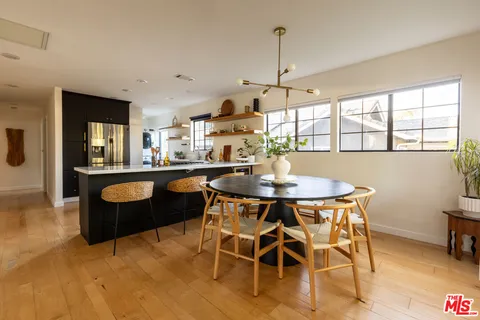 a dining room with furniture a window and kitchen view
