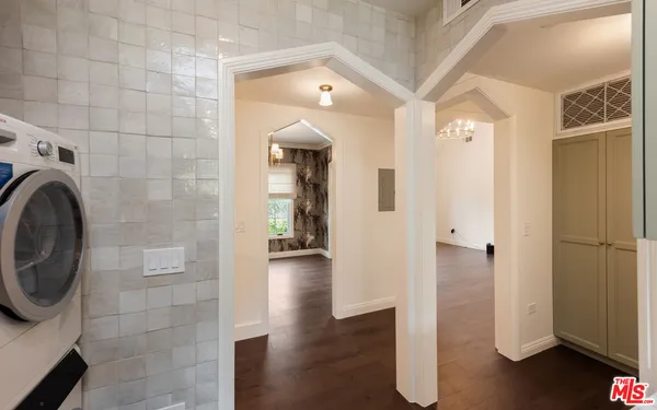 a view of a hallway with entryway wooden floor and front door