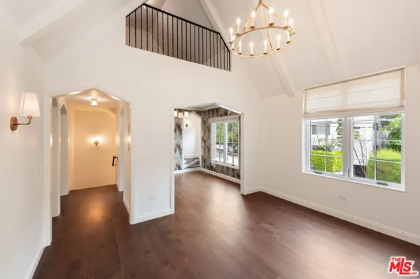 a view of a room with wooden floor and windows