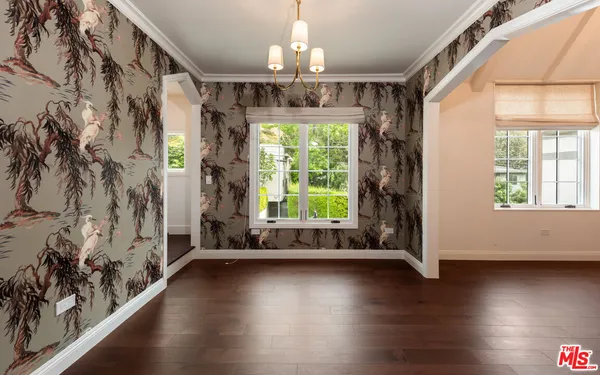 a view of an entryway with wooden floor