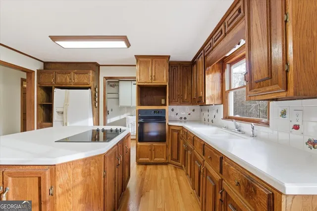 a large white kitchen with granite countertop a sink