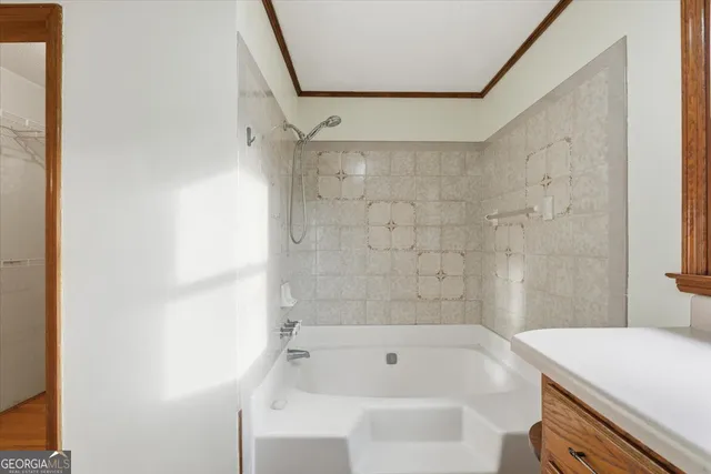 a bathroom with a granite countertop sink a mirror a shower and a bathtub