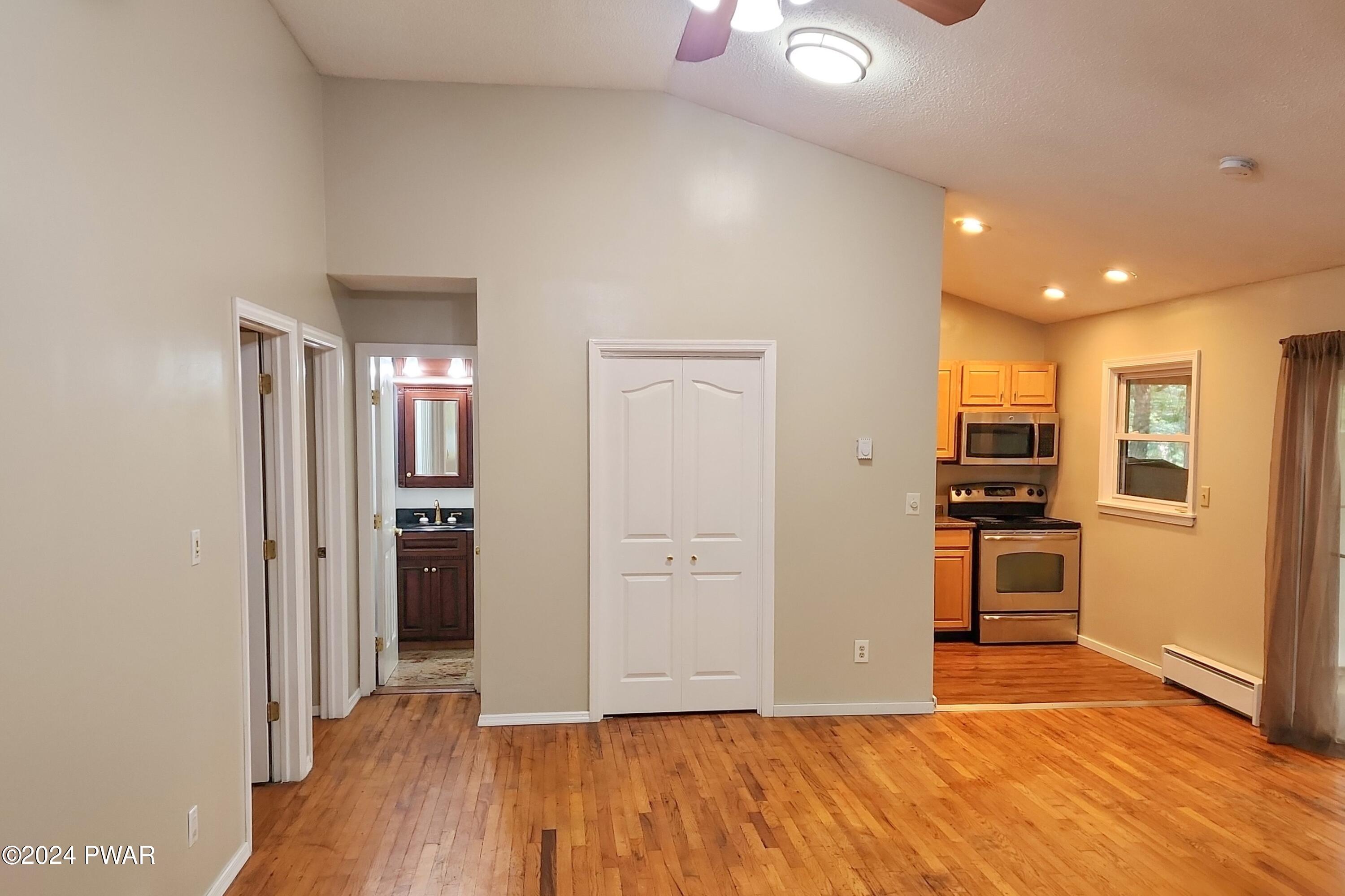 107 Rodeo Lane Hawley, PA 18428 - Photo 12 of 29 a view of a kitchen with wooden floor and a refrigerator