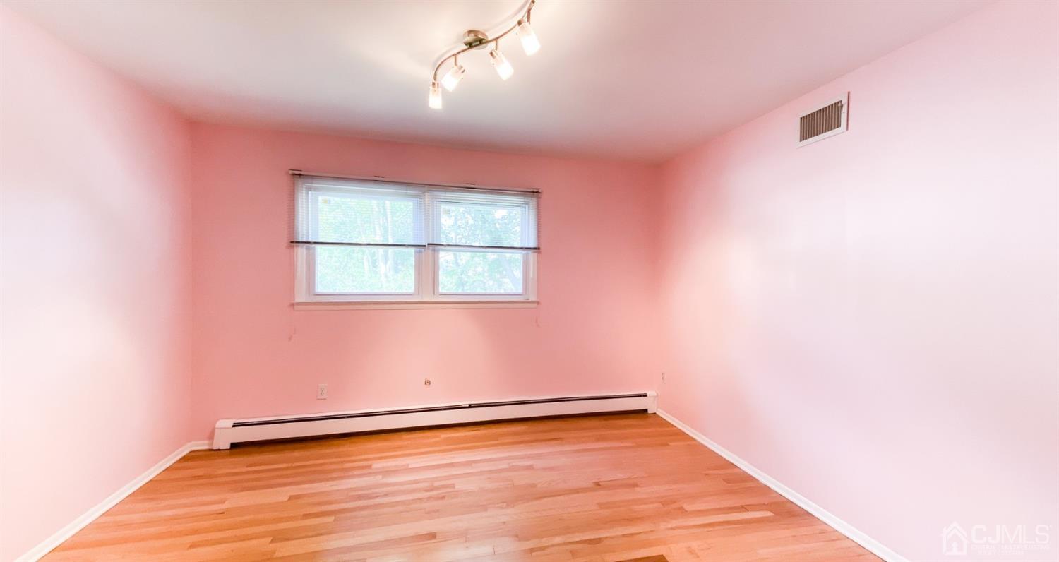 31 Lynnwood Road Edison, NJ 08820 - Photo 14 of 18 an empty room with wooden floor and windows