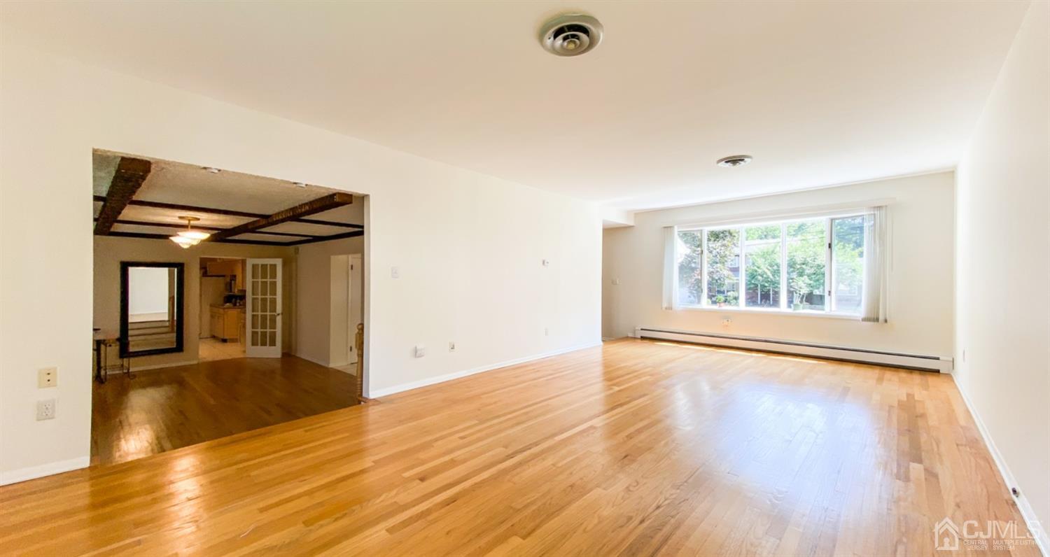 31 Lynnwood Road Edison, NJ 08820 - Photo 3 of 18 an empty room with wooden floor and windows