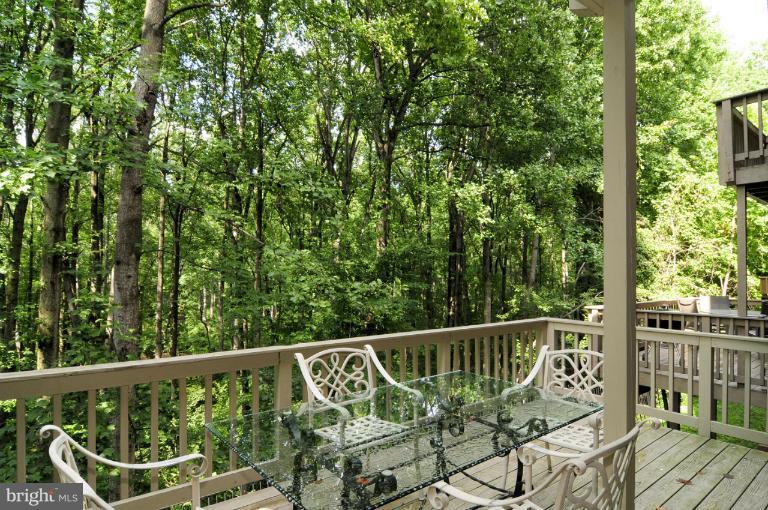 7841 Oracle Place Potomac, MD 20854 - Photo 25 of 29 a view of a balcony with floor to ceiling window and wooden fence