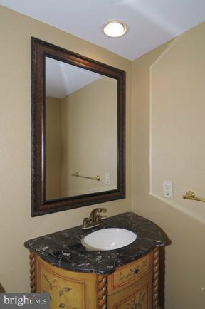 7841 Oracle Place Potomac, MD 20854 - Photo 9 of 29 a bathroom with a granite countertop sink and a mirror