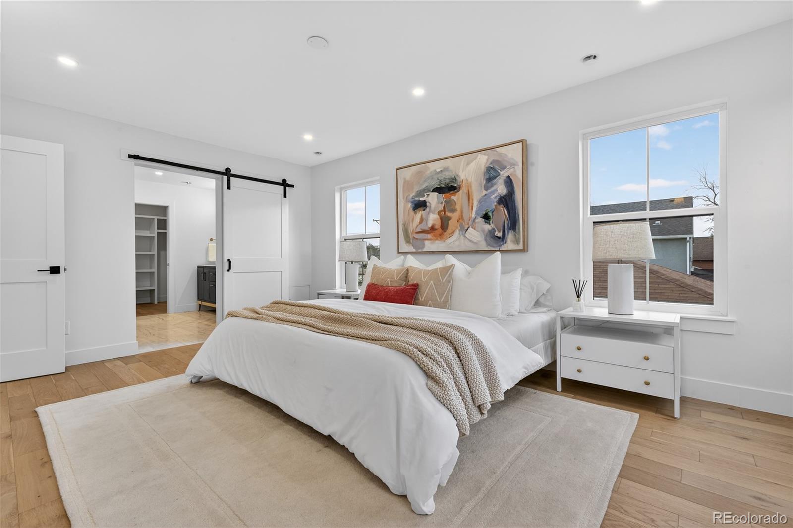 2362 South Acoma Street Denver, CO 80223 - Photo 23 of 50 a spacious bedroom with a bed and a window