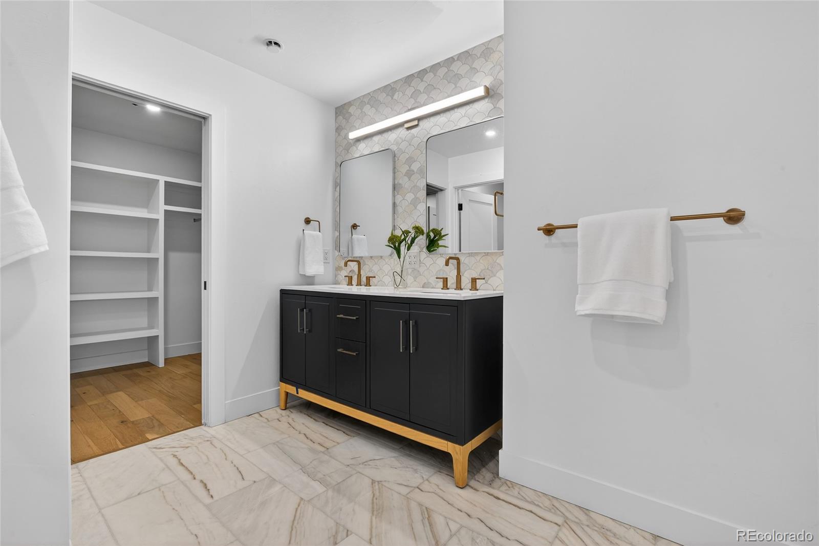 2362 South Acoma Street Denver, CO 80223 - Photo 25 of 50 a bathroom with a sink vanity and a mirror