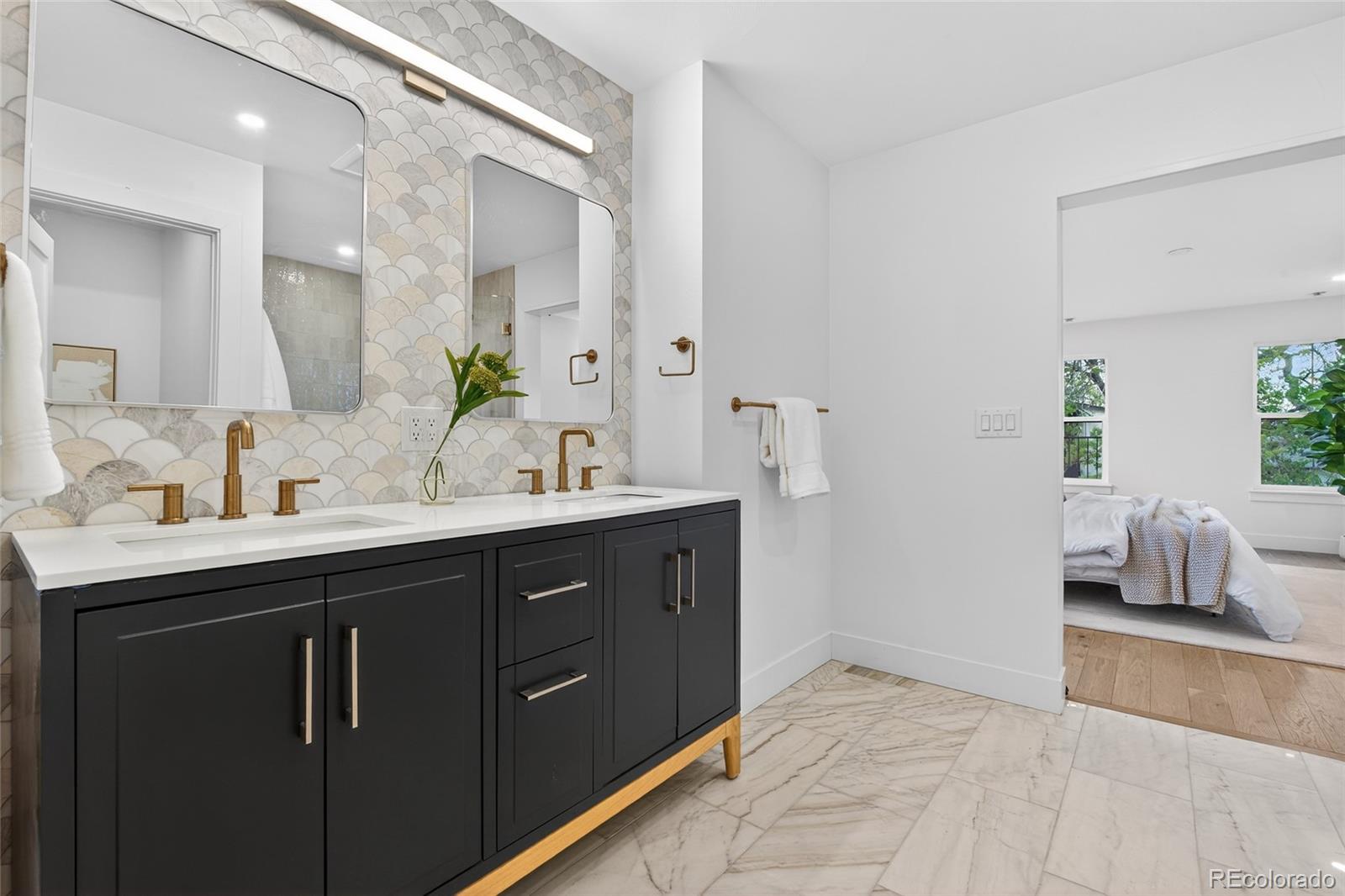2362 South Acoma Street Denver, CO 80223 - Photo 26 of 50 a bathroom with a sink and a mirror
