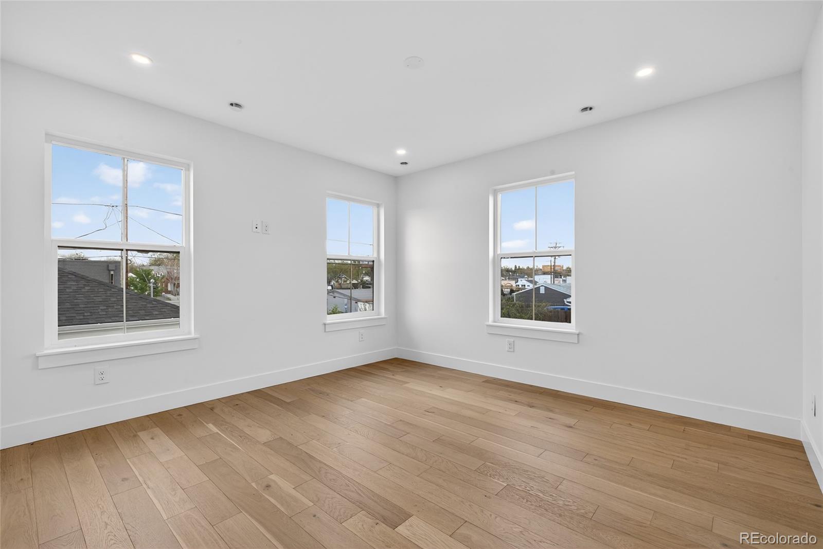 2362 South Acoma Street Denver, CO 80223 - Photo 30 of 50 a view of an empty room with wooden floor and a window