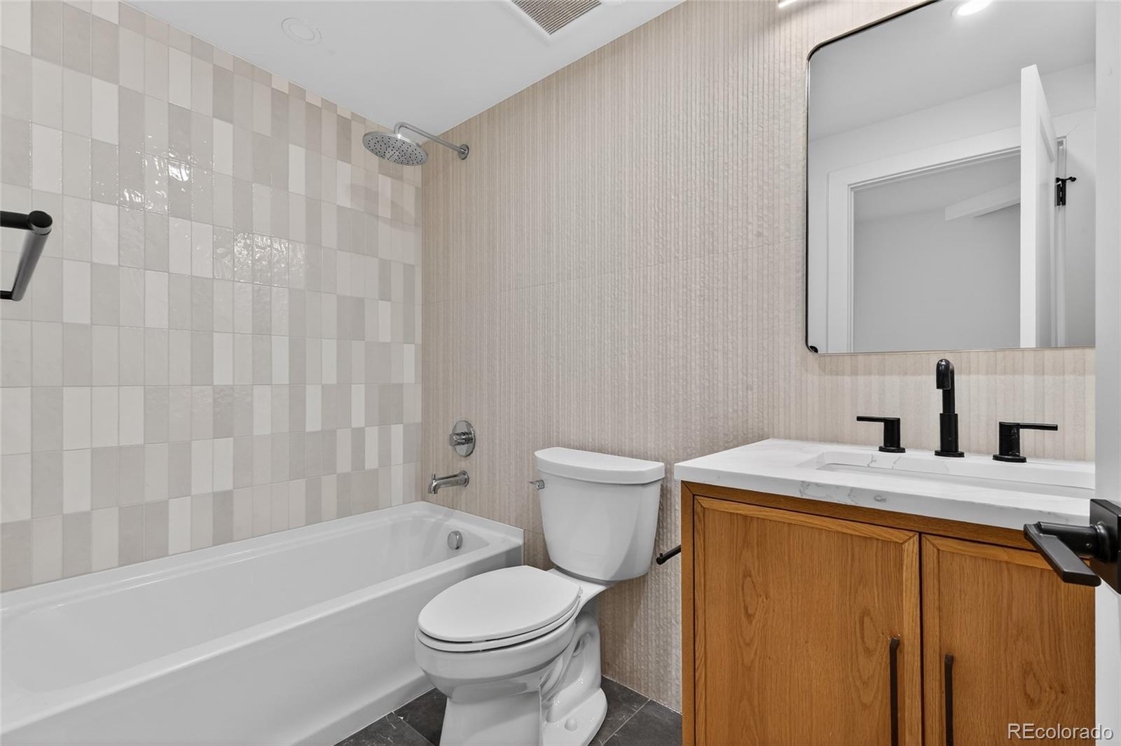 2362 South Acoma Street Denver, CO 80223 - Photo 33 of 50 a bathroom with a sink toilet and shower