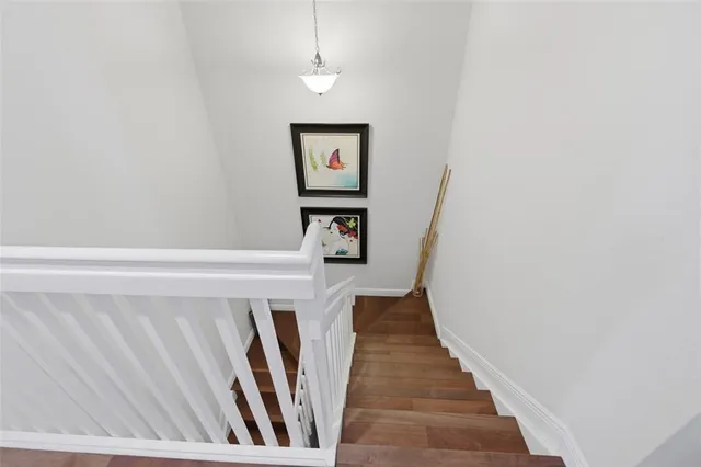 a view of a hallway with wooden floor and entryway