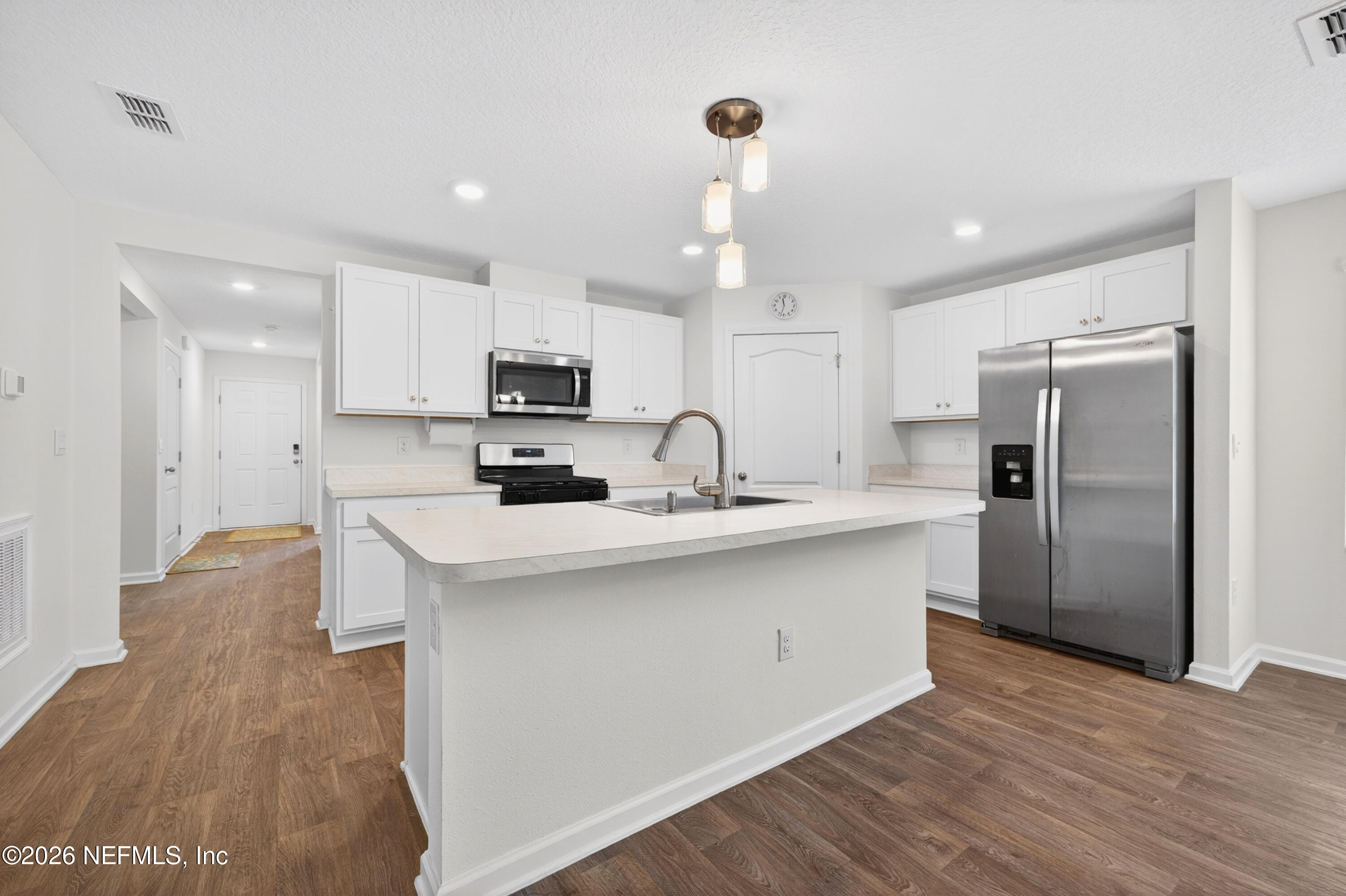 231 Encanto Way Street St. Augustine, FL 32084 - Photo 8 of 36 a kitchen with stainless steel appliances a refrigerator sink and microwave