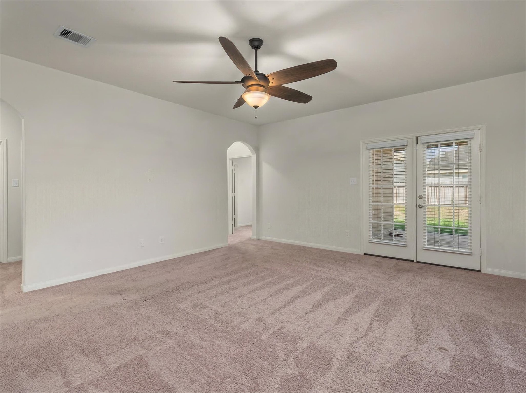 15215 Snowdrop Field Drive Humble, TX 77396 - Photo 11 of 35 a view of an empty room with a ceiling fan