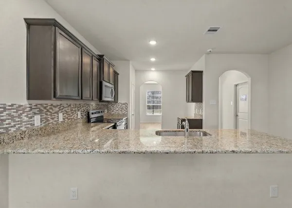 a bathroom with double vanity sinks granite vanity and a mirror