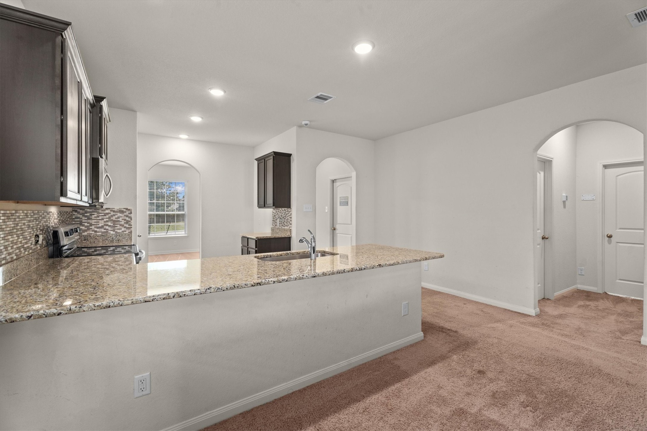 15215 Snowdrop Field Drive Humble, TX 77396 - Photo 16 of 35 a large kitchen with granite countertop a sink and a granite counter tops