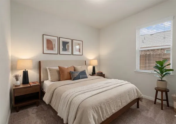 a bedroom with a bed and a potted plant