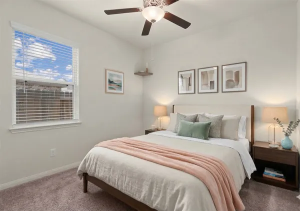a bedroom with a large bed and a chandelier