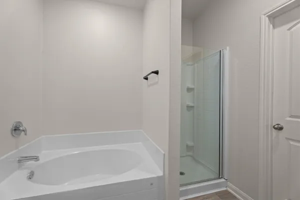 a white bath tub sitting next to a shower