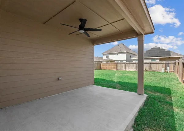 a view of a house with backyard and porch