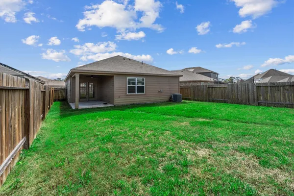 a front view of a house with yard and green space