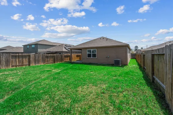 a view of a house with wooden fence
