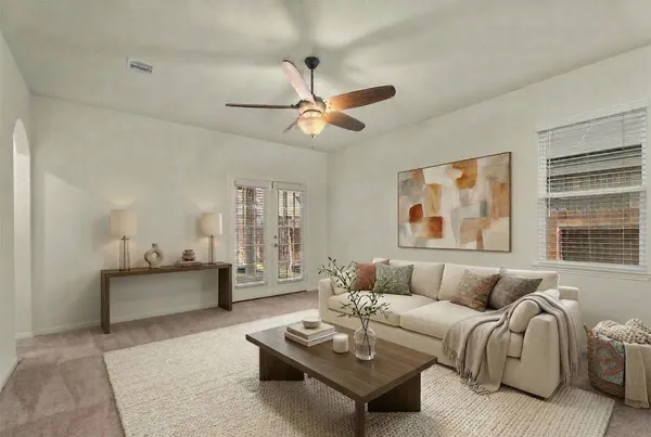 a living room with furniture and a large window