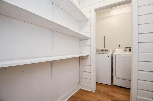 a view of walk in closet with empty racks