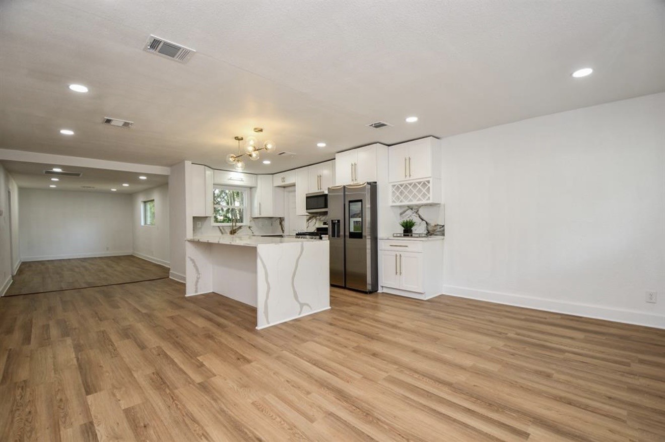 6834 St Augustine Street Houston, TX 77021 - Photo 4 of 21 a kitchen with stainless steel appliances kitchen island granite countertop a refrigerator and a sink