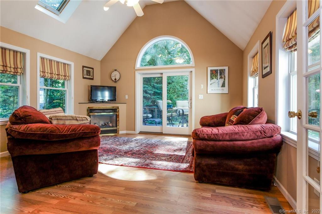 412 Warpas Road Madison, CT 06443 - Photo 1 of 1 a living room with fireplace furniture and a large window