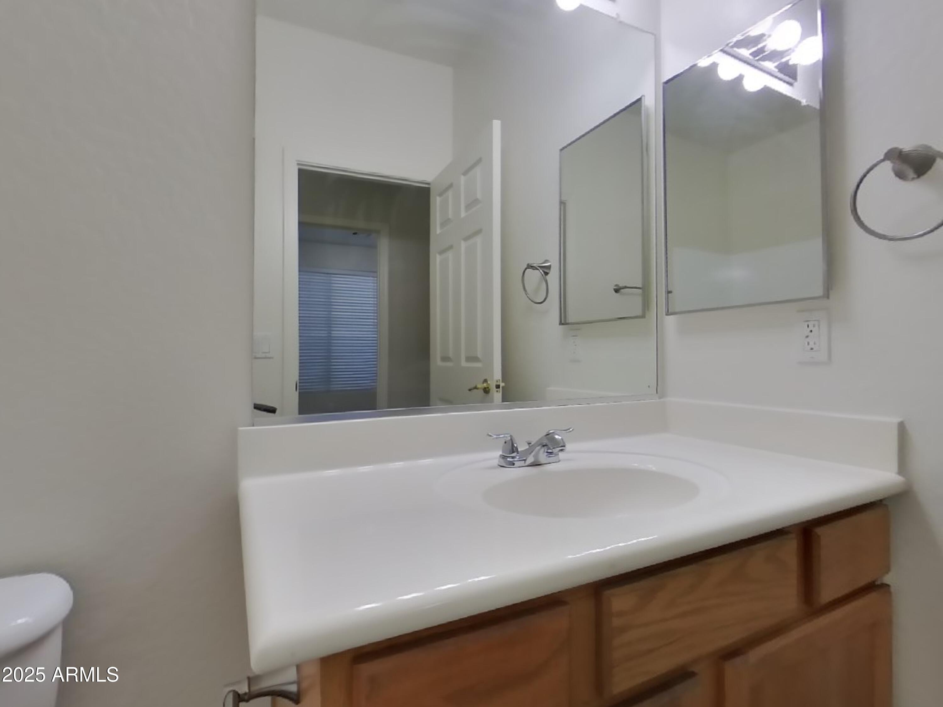 4333 East Ivanhoe Street Gilbert, AZ 85295 - Photo 14 of 16 a bathroom with a sink and a mirror