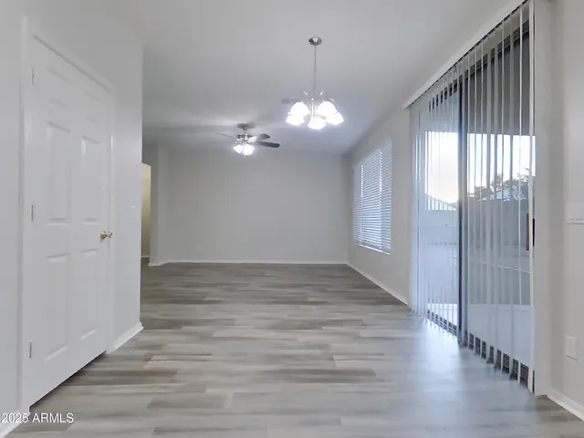 a view of an empty room and wooden floor