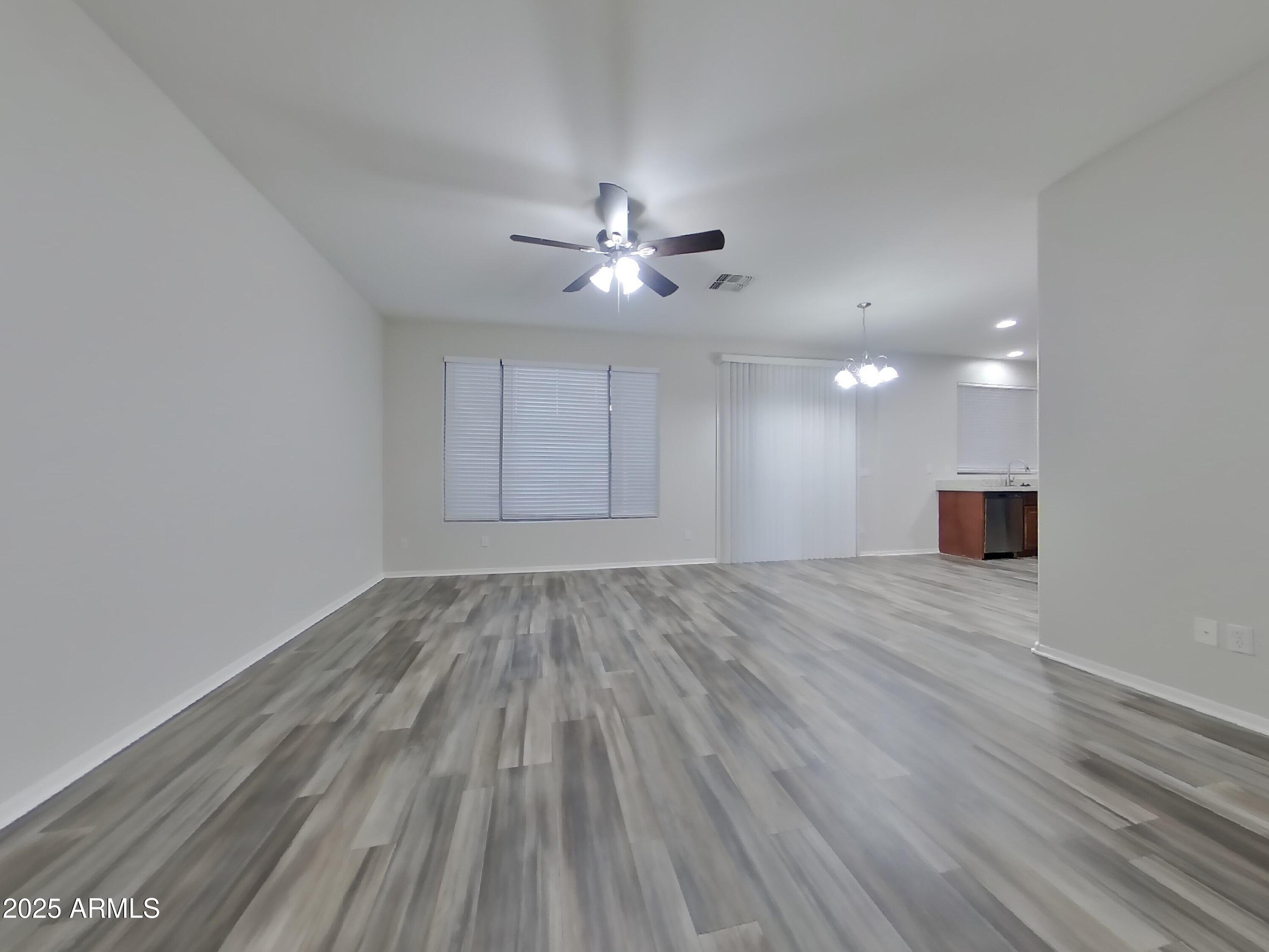 4333 East Ivanhoe Street Gilbert, AZ 85295 - Photo 5 of 16 wooden floor in an empty room with a window