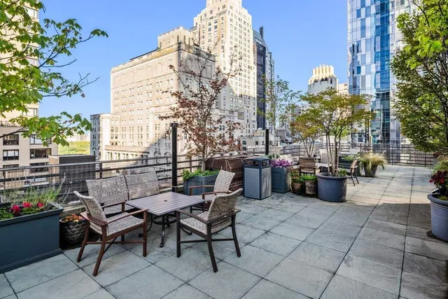 a view of a chairs and table in the back yard of the house