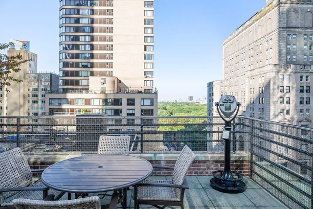 a view of a terrace with glass table and chairs