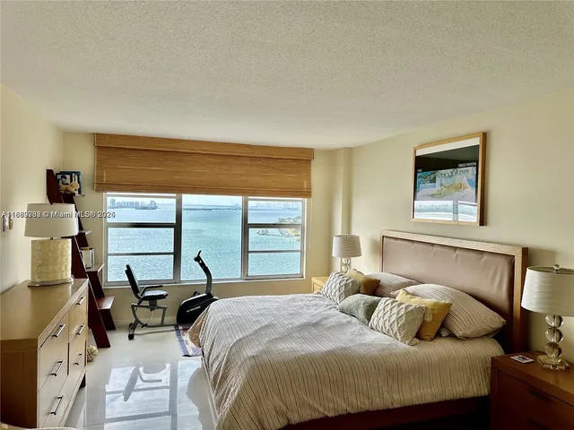 a bedroom with a bed and glass window
