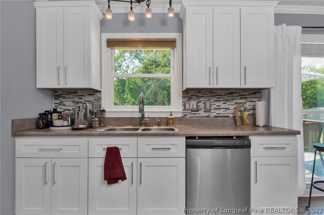 1021 Locks Creek Road Fayetteville, NC 28312 - Photo 17 of 34 a kitchen with granite countertop white cabinets and white appliances