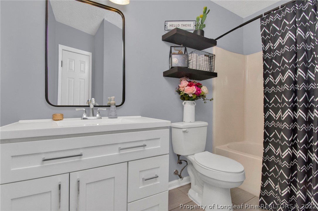 1021 Locks Creek Road Fayetteville, NC 28312 - Photo 20 of 34 a bathroom with a sink vanity mirror and toilet