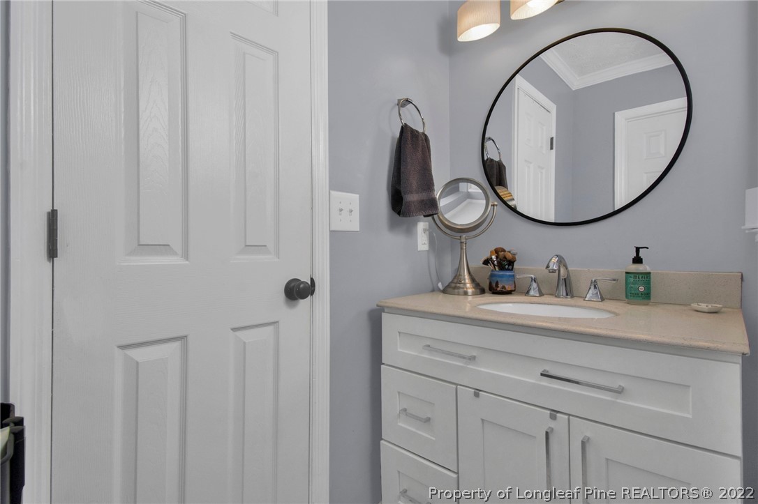 1021 Locks Creek Road Fayetteville, NC 28312 - Photo 21 of 34 a bathroom with a sink vanity and a mirror