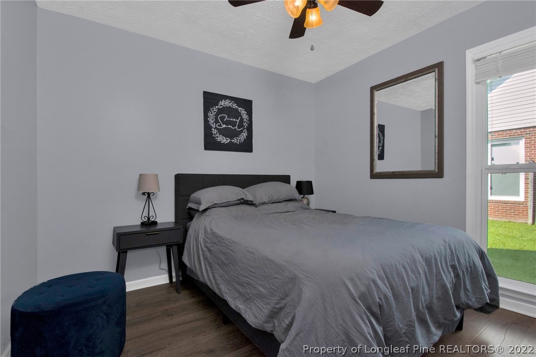 1021 Locks Creek Road Fayetteville, NC 28312 - Photo 26 of 34 a bedroom with a bed and wooden floor