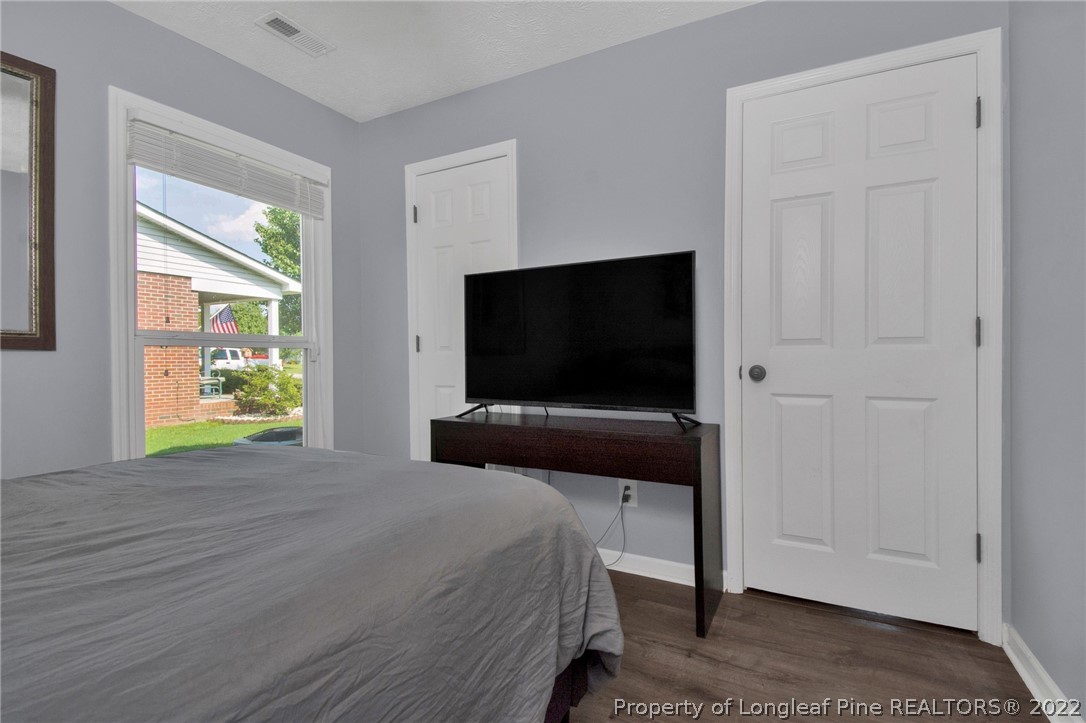 1021 Locks Creek Road Fayetteville, NC 28312 - Photo 27 of 34 a bedroom with a bed and flat screen tv