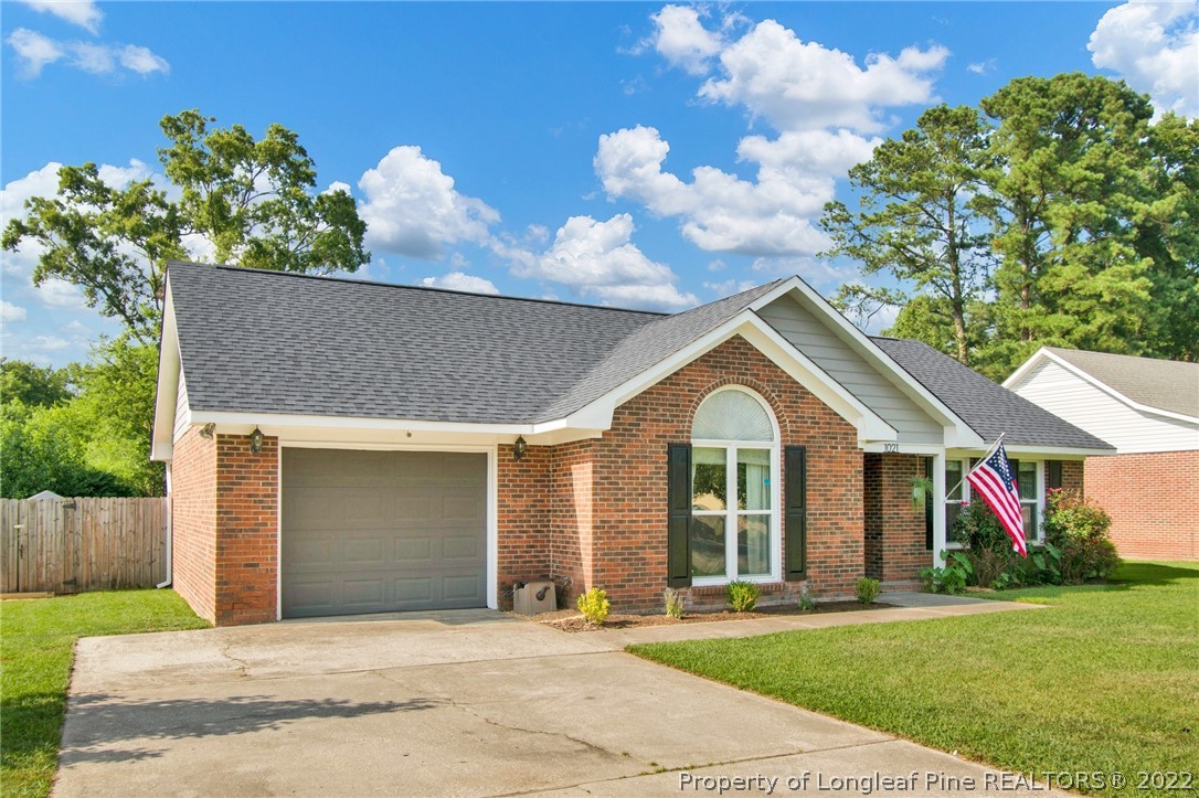 1021 Locks Creek Road Fayetteville, NC 28312 - Photo 4 of 34 a front view of a house with a garden and trees
