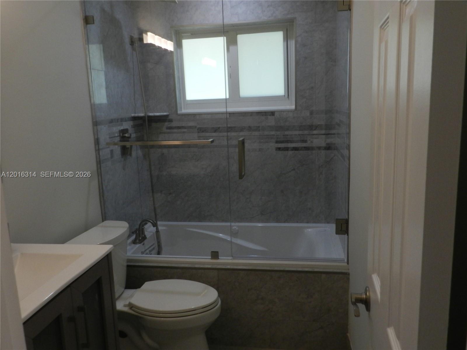 305 Northwest 42nd Street Boca Raton, FL 33431 - Photo 11 of 31 a bathroom with a sink a toilet and a bathtub