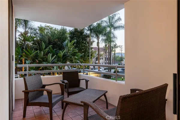 a dining room with furniture and a floor to ceiling window