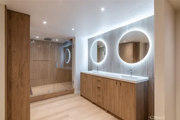 a bathroom with a double vanity sink and mirror